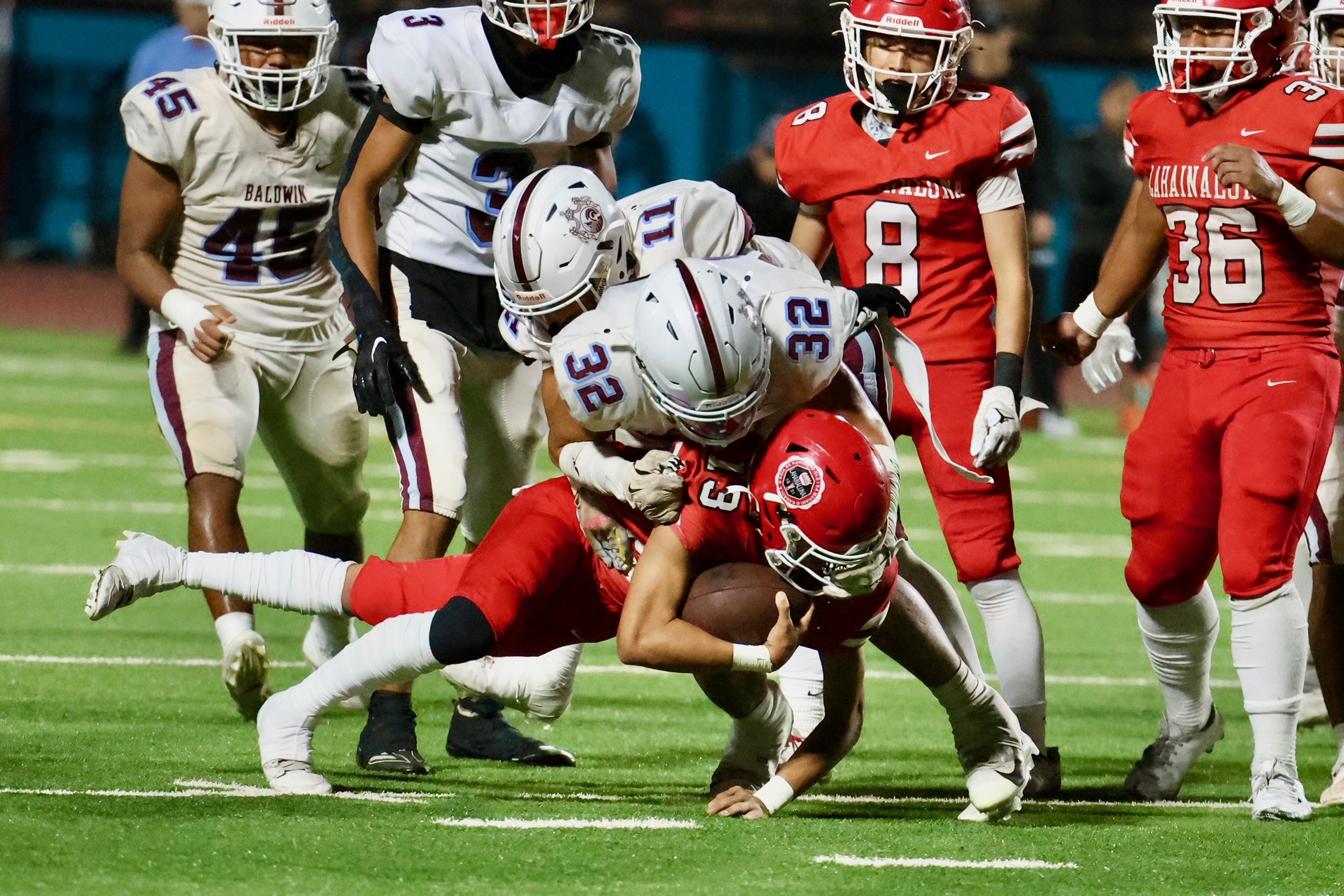 Baldwin's Jackson Sebastian tackles Lahainaluna's Jaeden-Ian Pascua in the Lunas' 7-3 win over the Bears on Friday at King Kekaulike Stadium. TYLER ORIKASA photo