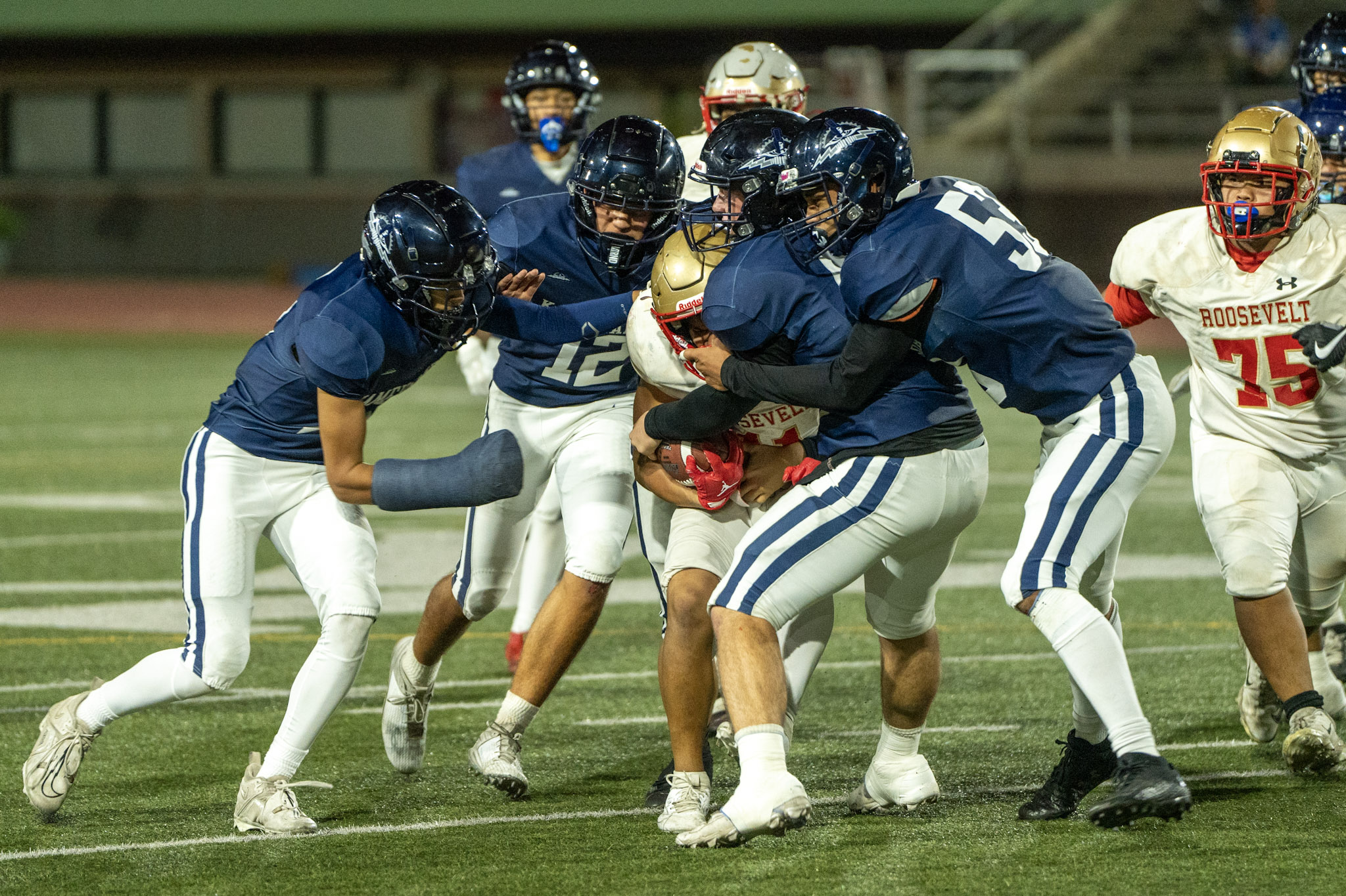 The Kamehameha Schools Maui defense makes a gang tackle in their 60-26 Division II state semifinal win over Roosevelt last week. Photo courtesy of Kamehameha Schools Maui