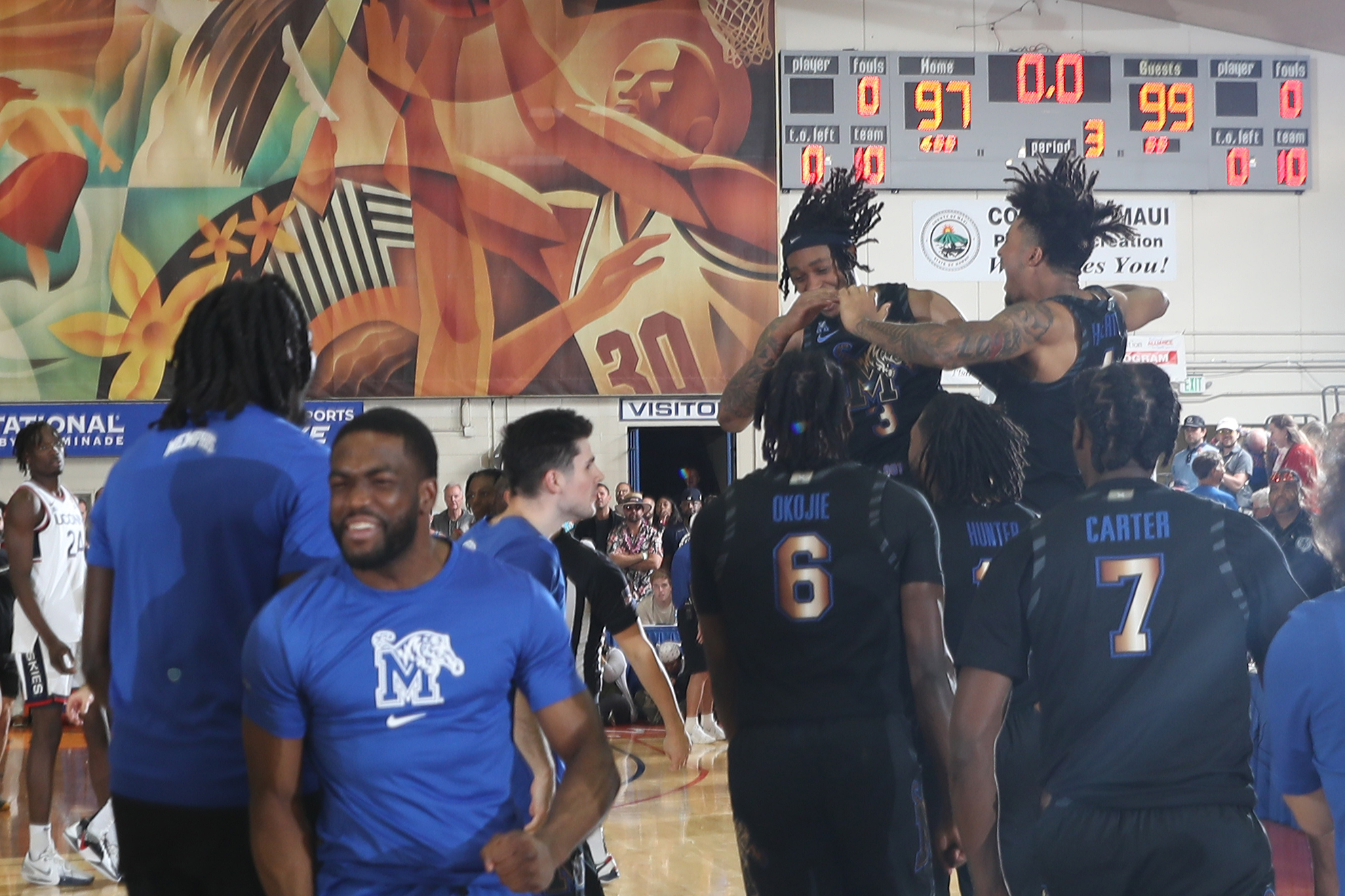 The University of Memphis Tigers celebrate their 99-97 overtime win over the UConn Huskies in the first round of the Maui Invitational at the Lahaina Civic Center on Monday. (Photo by Brian Spurlock/Icon Sportswire)