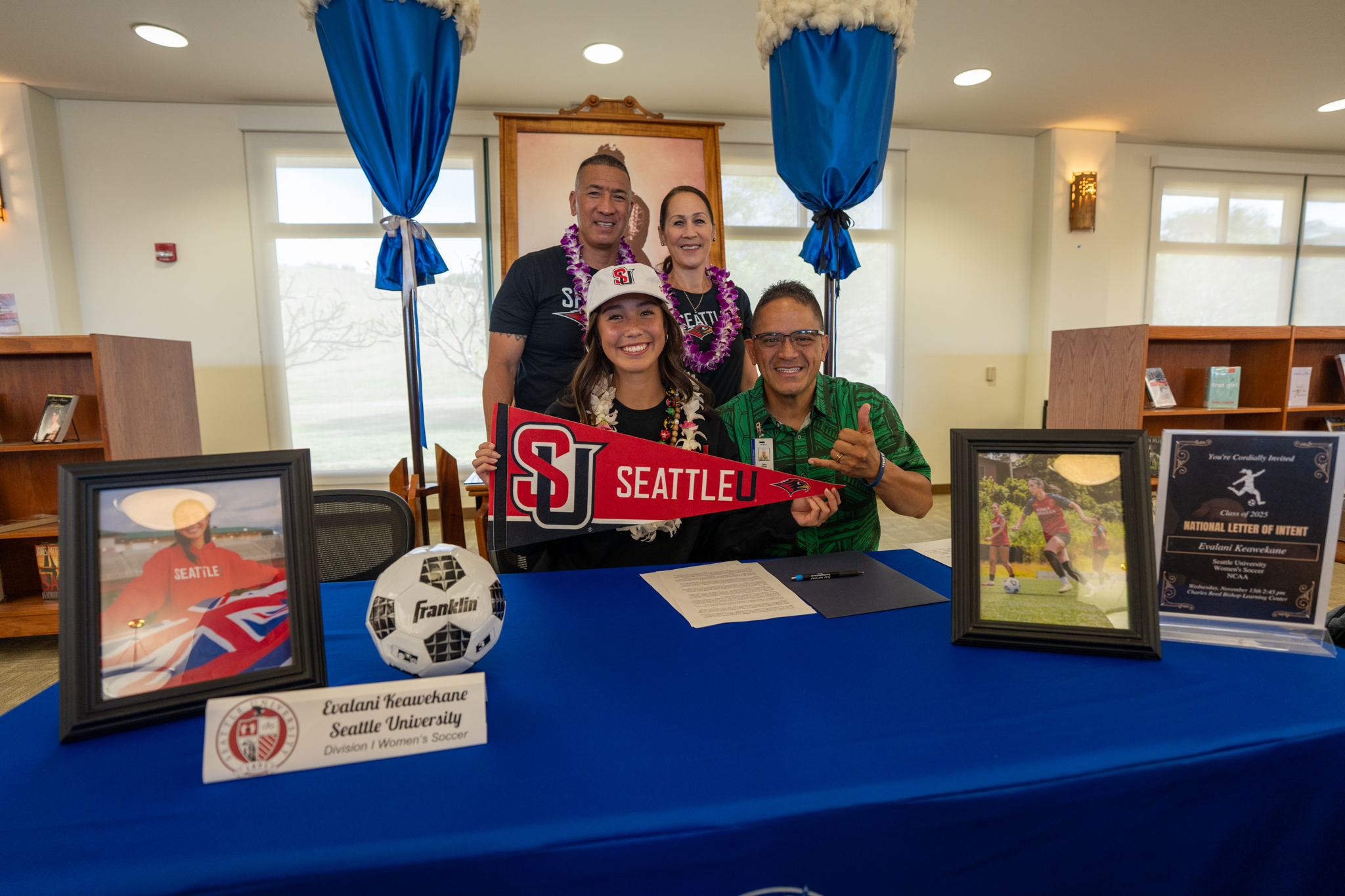 Evalani Keawekane holds a Seattle University pennant after signing her National Letter of Intent to attend the school on a women's soccer scholarship. Her parents Amos Keawekane and Mitzie Keawekane, as well as KSM college counselor Larry Kekaulike (far right) are also pictured at the ceremony on Wednesday. Kamehameha Schools photo