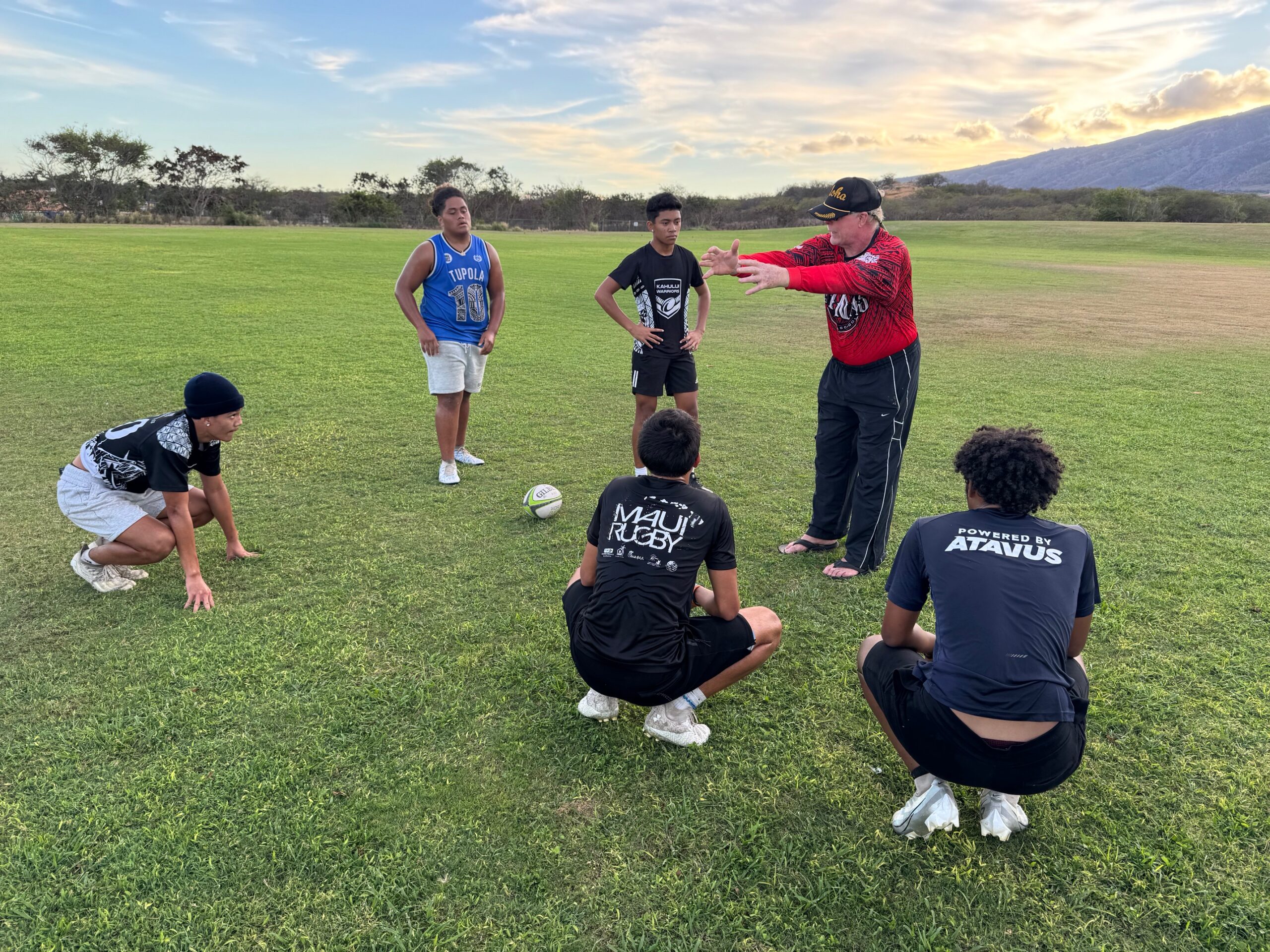 Jack Breen (red shirt), founder of the Maui Rugby Union, guides members of the U18 boys team at practice on Tuesday at Maui Lani Regional Park. HJI / ROB COLLIAS photo