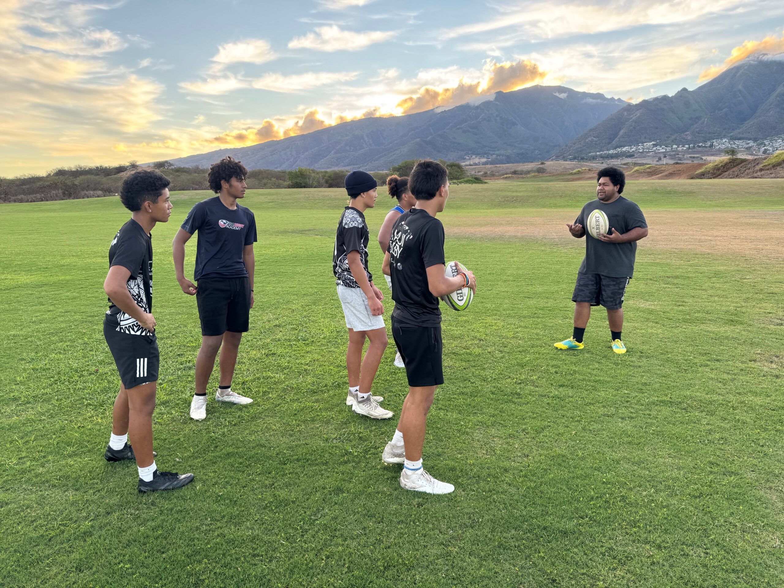 Vili Toluta'u (right) talks to Maui Rugby Union U18 players at practice at Maui Lani Regional Park on Tuesday. HJI / ROB COLLIAS photo