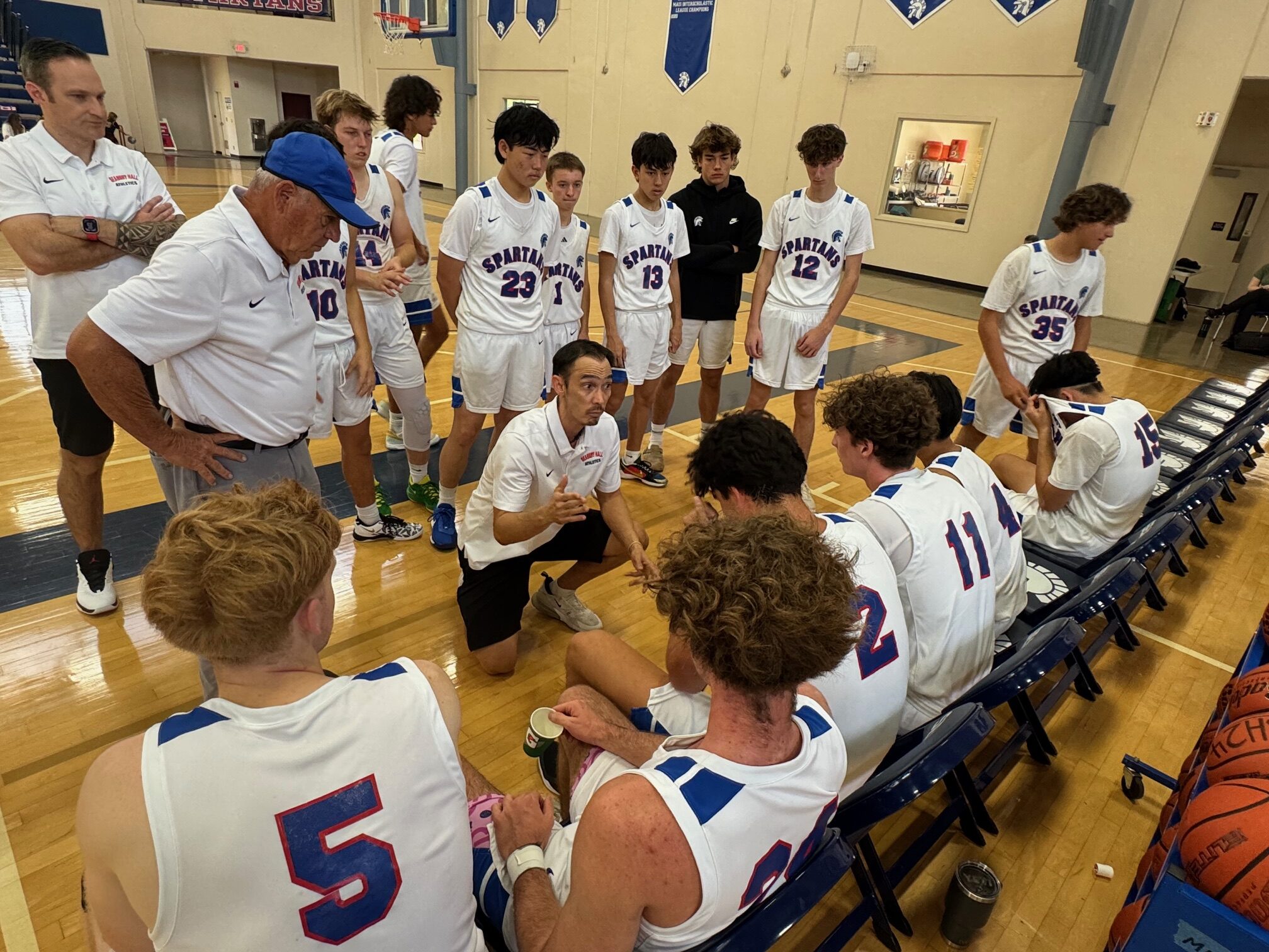 Seabury Hall head coach Scott Prather gives instruction to his boys baskteball team on Saturday during a timeout in the Spartans' 63-37 win over Hawaii Baptist Academy. HJI / ROB COLLIAS photo