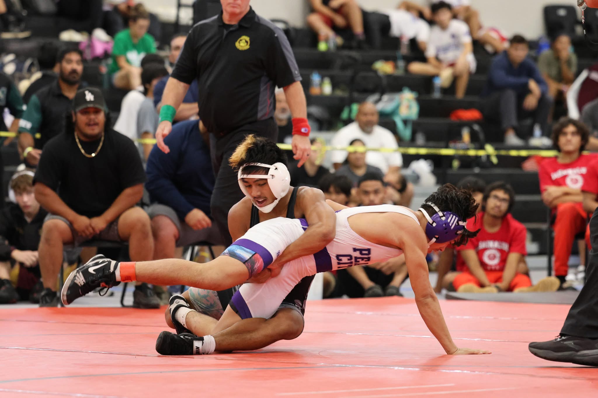 Molokai High School's Jona Dudoit (behind) controls Irving Bicoy of Pearl City in their 120-pound boys final at the Garner Ivey Maui Invitational Tournament in Kihei on Saturday. Dudoit won the match 6-3. JASON HAYASE photo