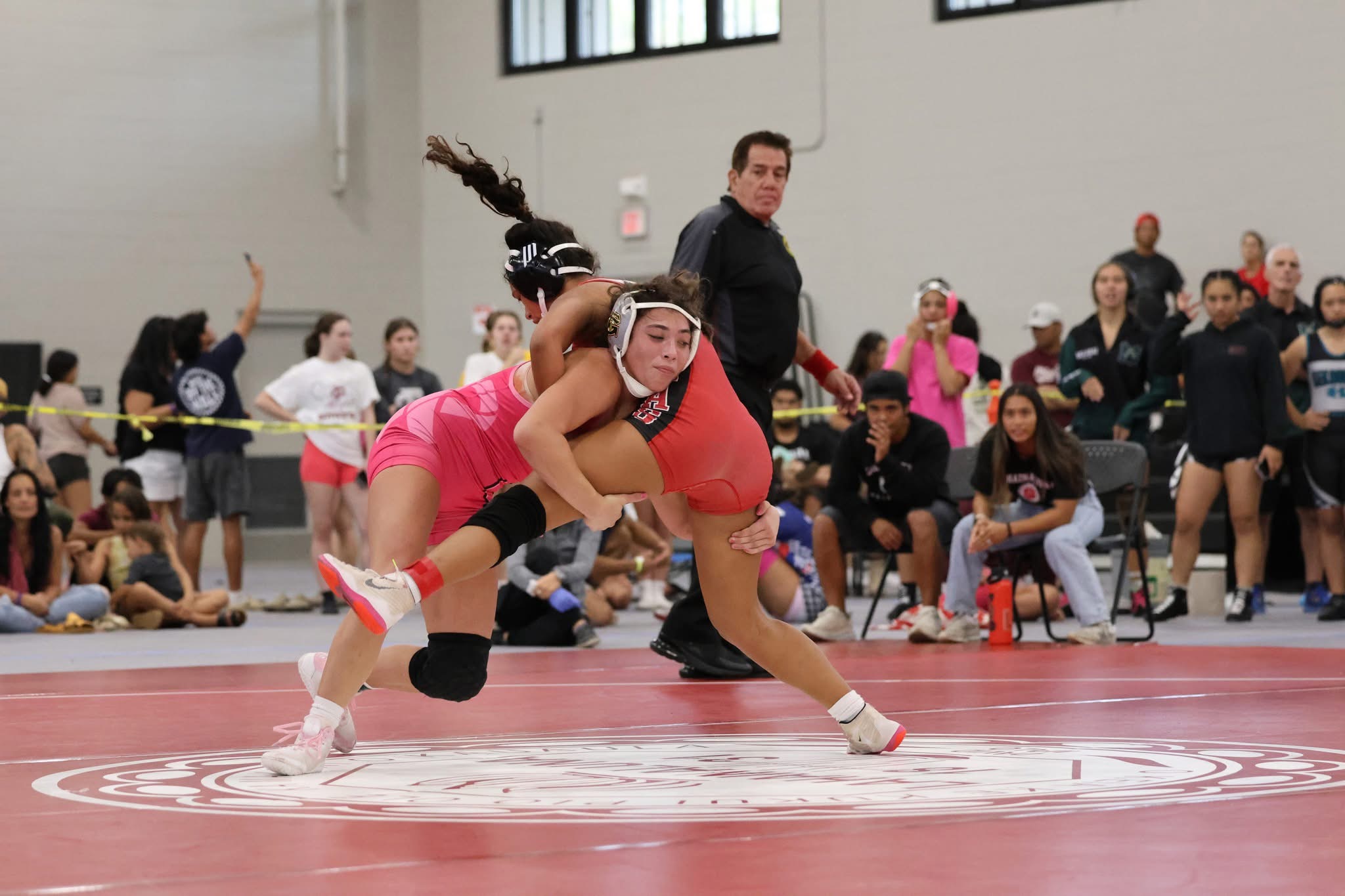 Kailea Takahashi (left) of Forest Grove (Ore.) High School beat Safirah Ladore of Lahainaluna in their 130-pound final at the Garner Ivey Maui Invitational Tournament on Saturday in Kihei. Takahashi won the match 7-4 in overtime. JASON HAYASE photo