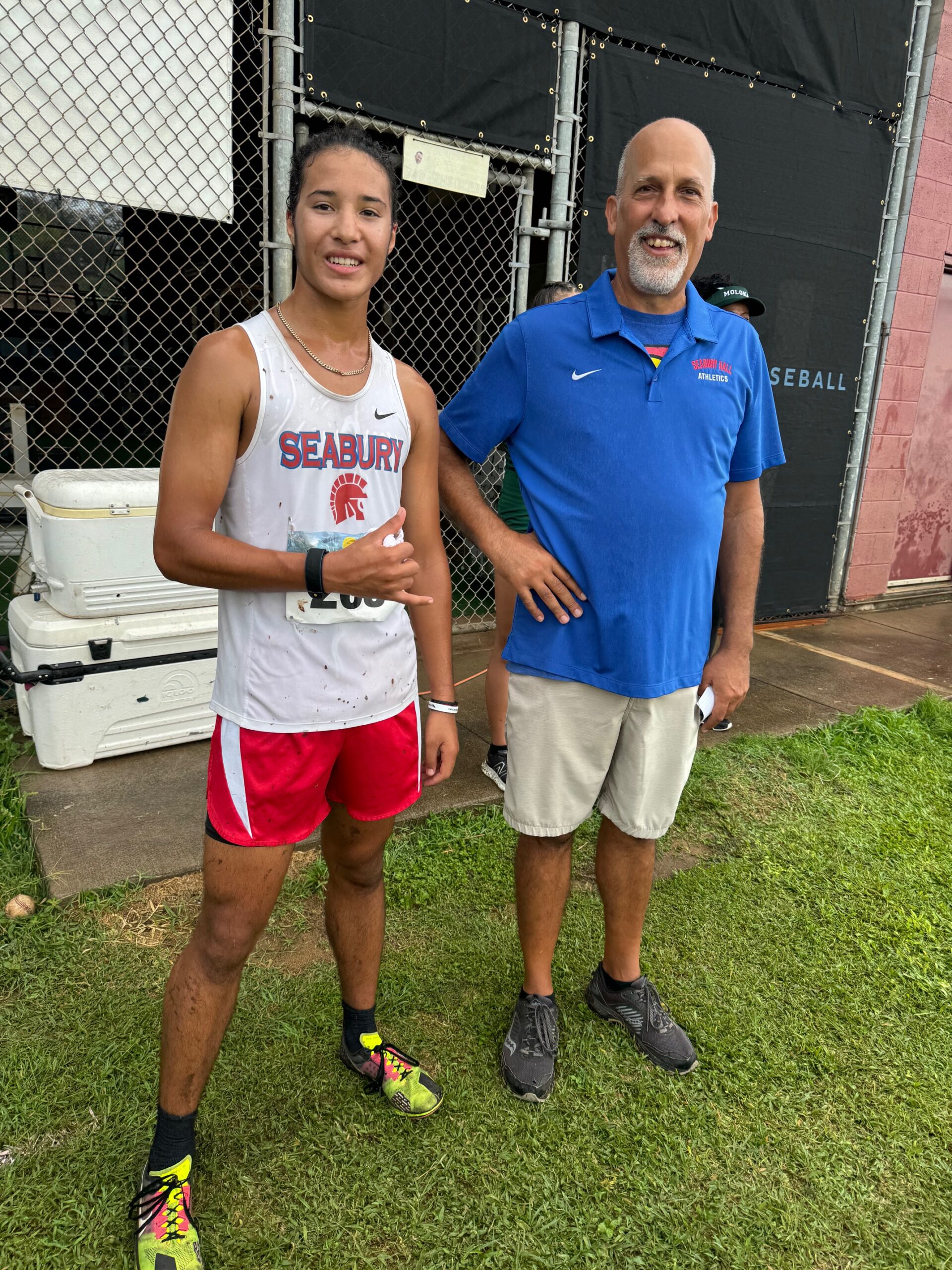 Seabury Hall's Micah Brighton (left) stands with coach Bobby Grossman on Saturday at Baldwin High School. HJI / ROB COLLIAS photo