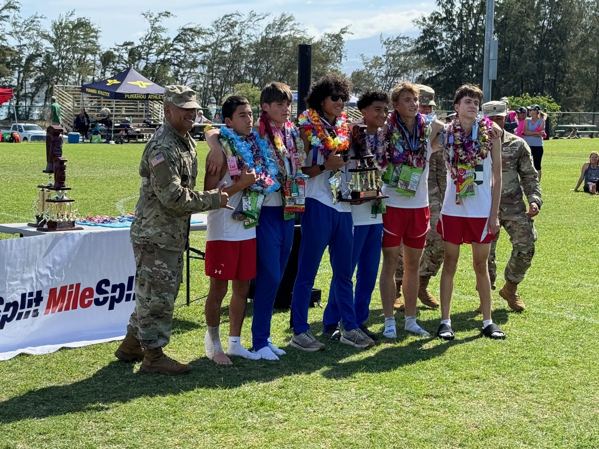 The Seabury Hall boys cross country team finished second in the Division II standings on Satiurday morning at Keopuolani Park. Micah Brighton, who finished fourth individually, holds the team tropy. HJI / ROB COLLIAS photo