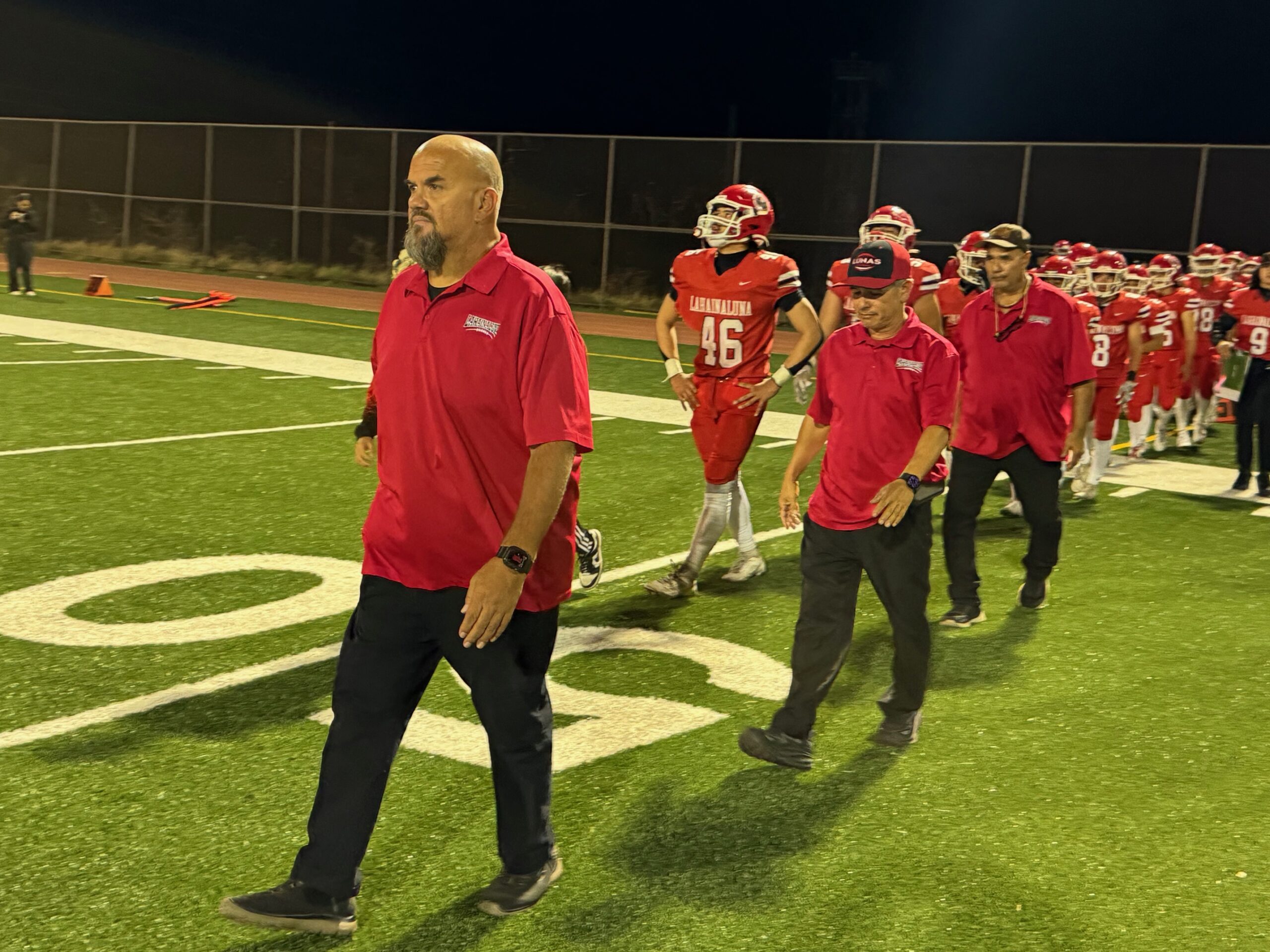 Lahainaluna head coach Dean Rickard leads the Lunas towards the handshake line following their 40-13 loss to Leilehua in the Division I state quarterfinals on Saturday at Sue Cooley Stadium. HJI / ROB COLLIAS photo