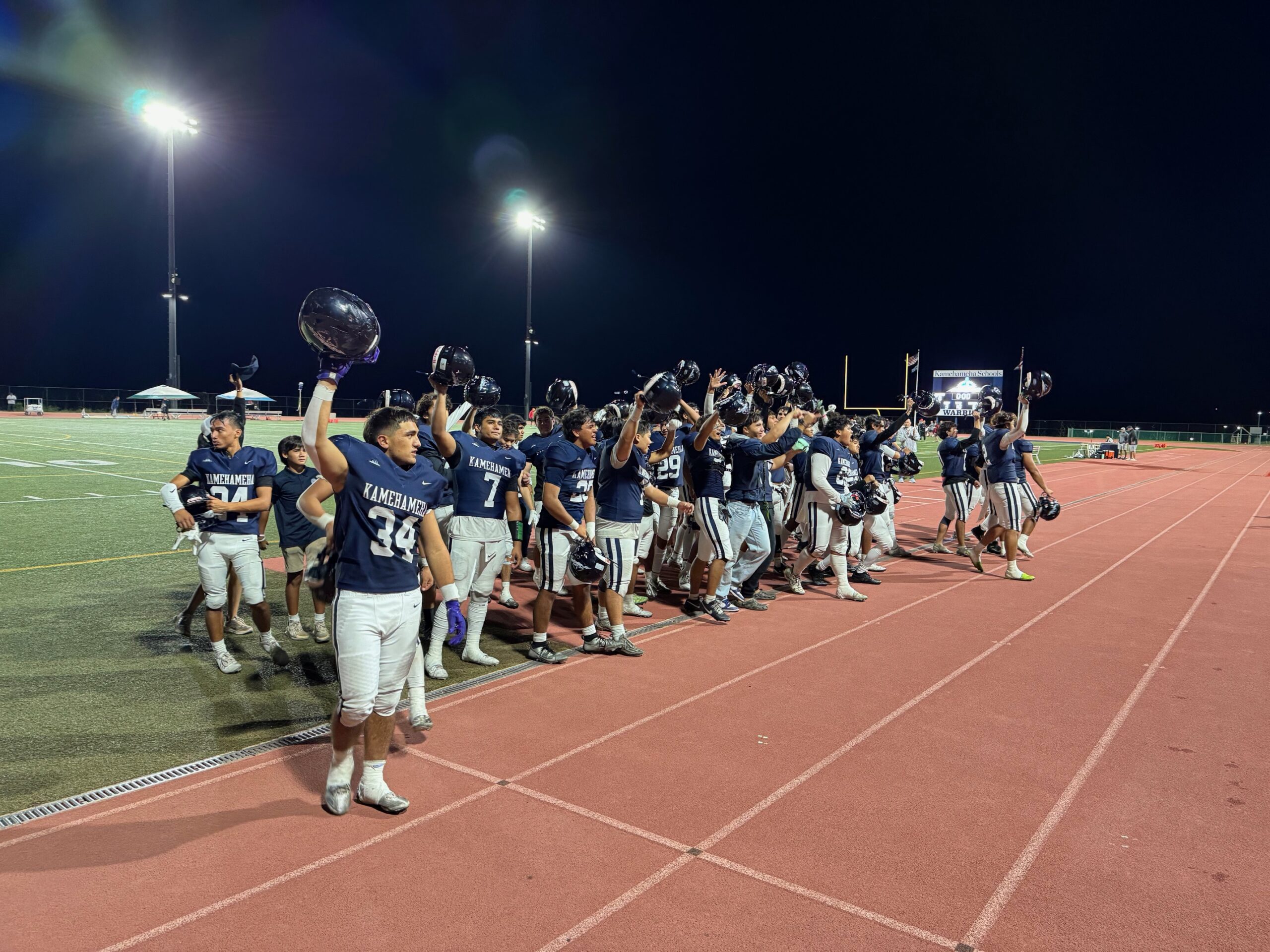 The Kamehameha Schools Maui football team celebrates and salutes the crowd following the post-game signing of their alma mater. HJI / ROB COLLIAS photo