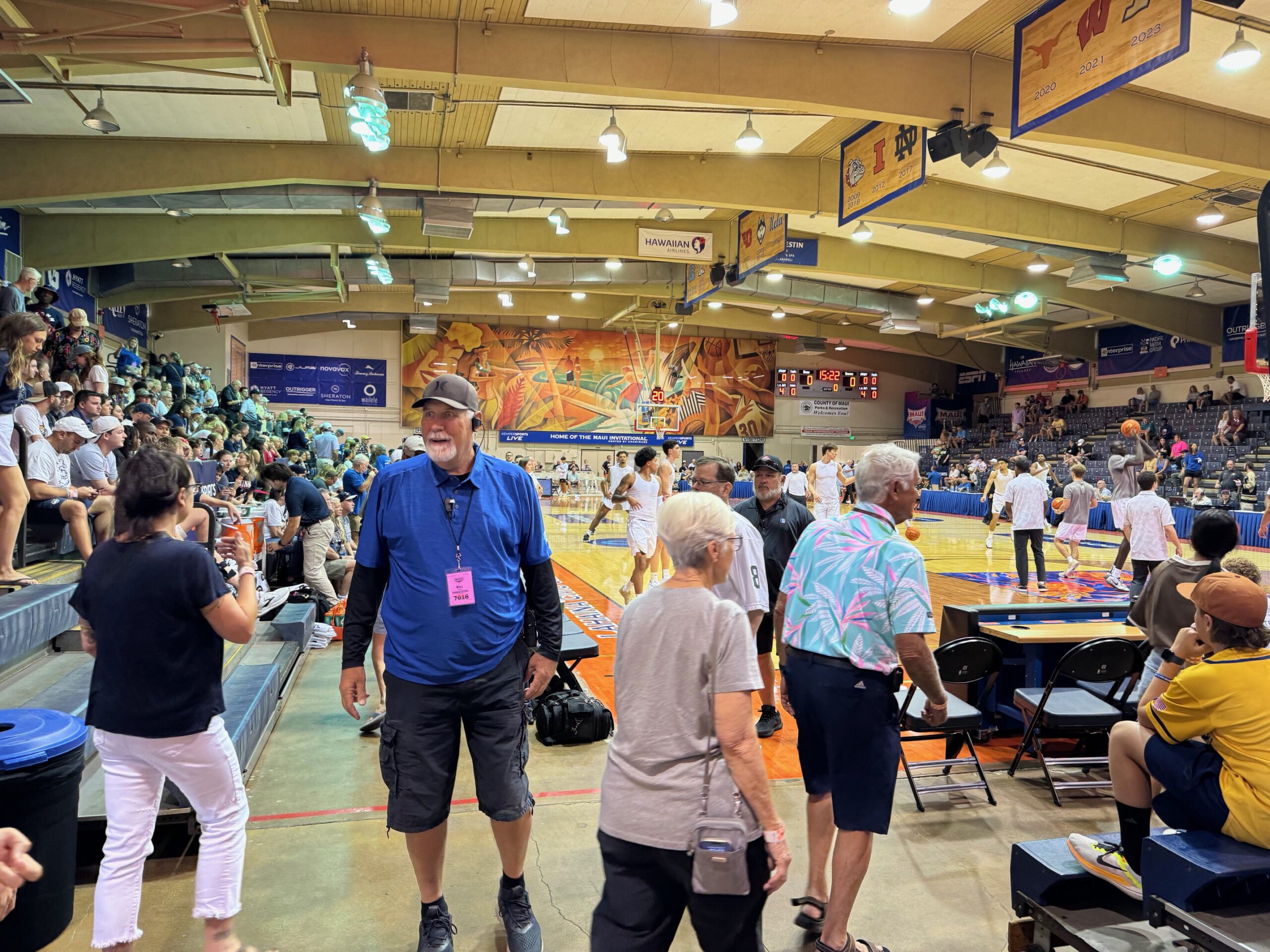 Bill Naylor has been usher for 28 Maui Invitationals at the Lahaina Civic Center. He mans Gate 3 as he guides people to their seats for the Colorado vs. Connecticut on Tuesday. HJI / ROB COLLIAS photo