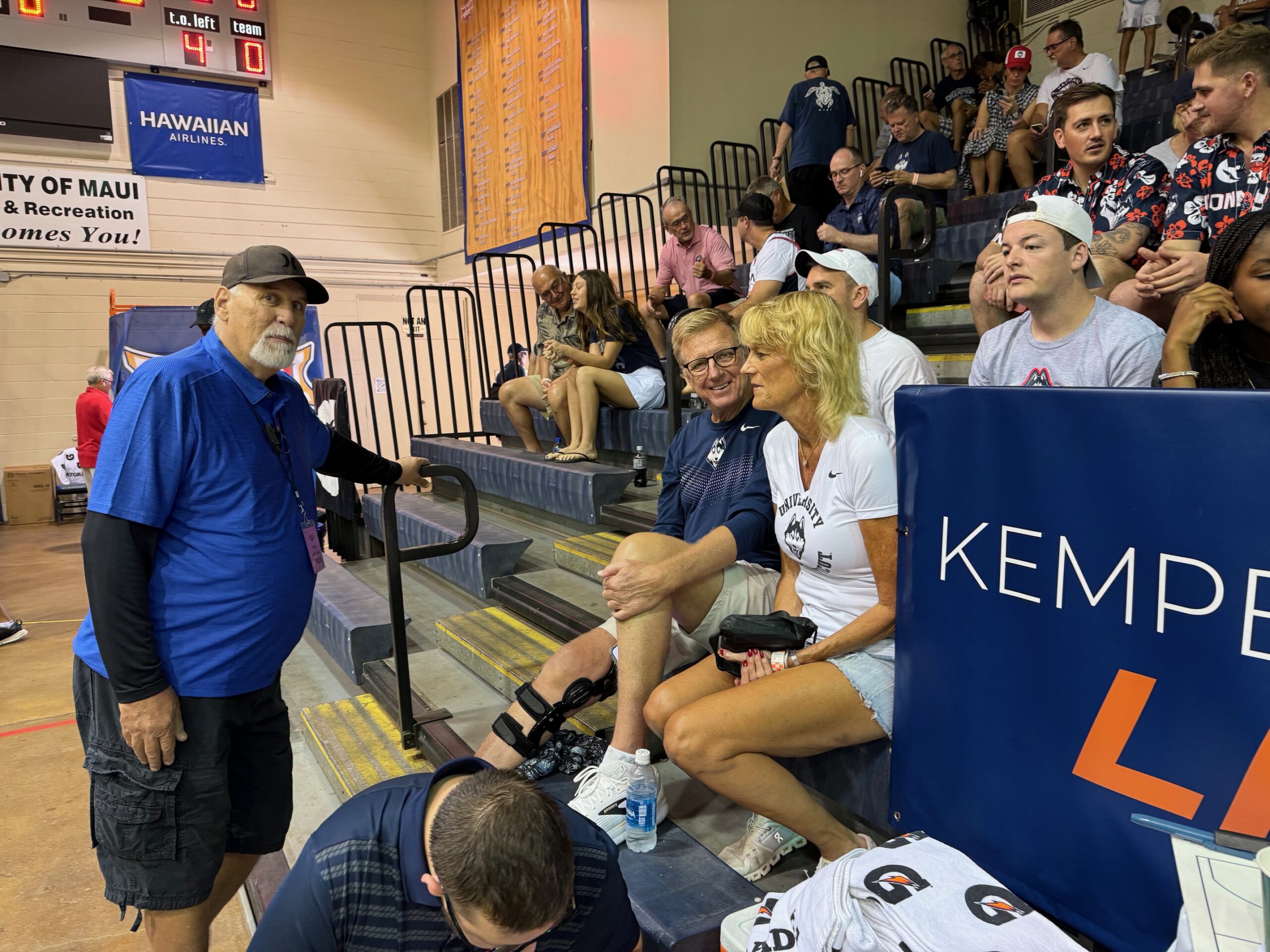 Longtime usher Bill Naylor talks story with Bob and Wendy Stauffer prior to the UConn-Colorado game on Tuesday in the Maui Invitational at the Lahaina Civic Center. HJI / ROIB COLLIAS photo